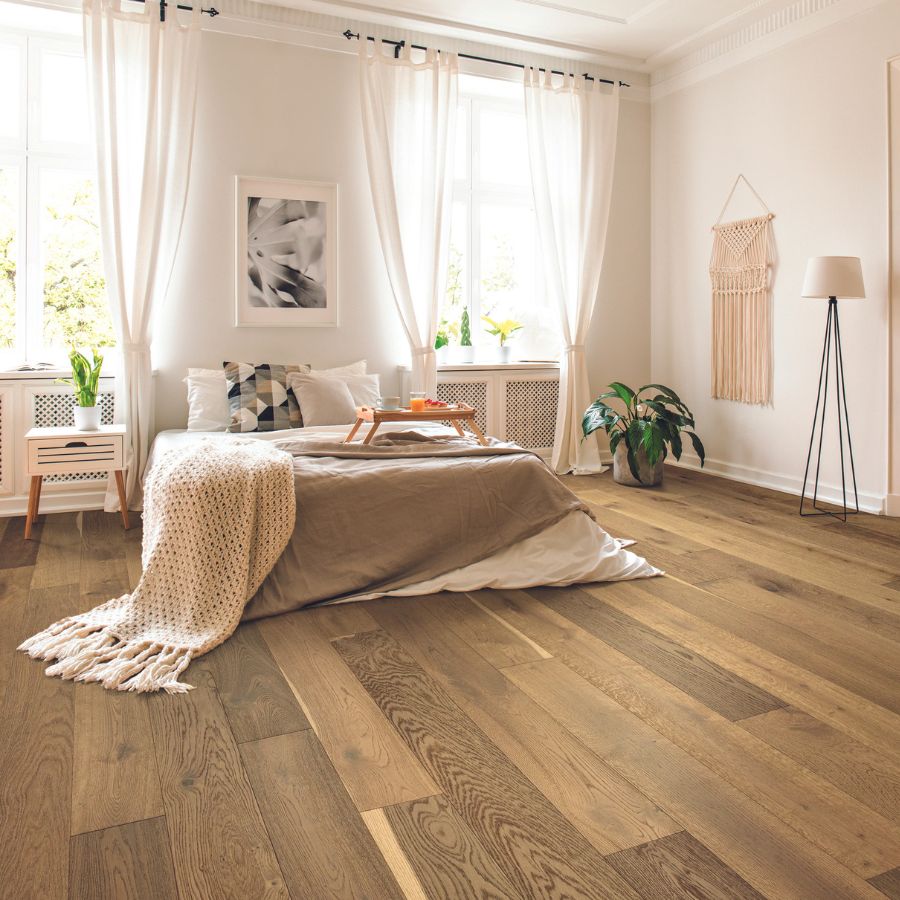 Hardwood flooring in bedroom, plants, lamps, and windows 